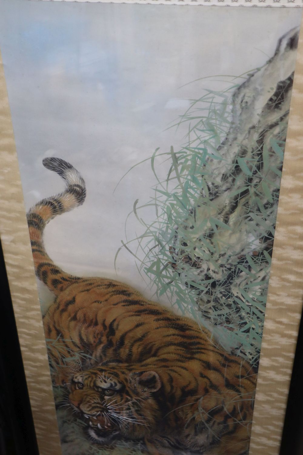 Chinese School (20th century), study of a tiger in a mountainous landscape, watercolour on silk, 125cm x 41cm approx